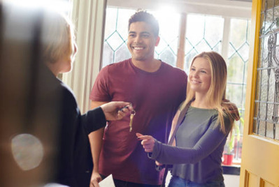 A couple receiving keys to a new home