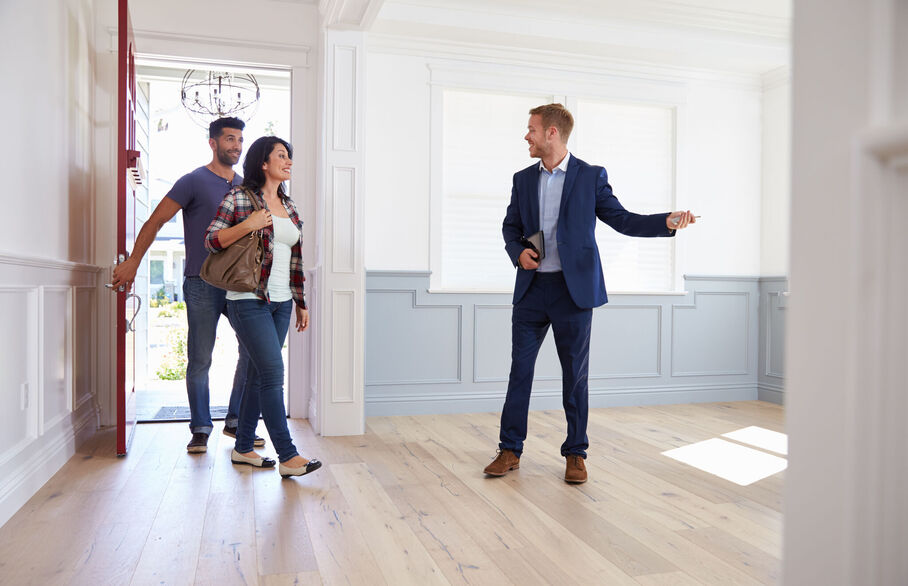 Estate agent showing couple around property