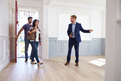 Estate agent showing couple around property