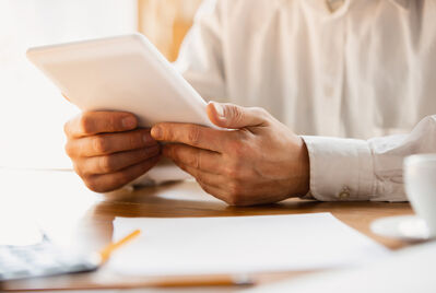 Someone holding a tablet
