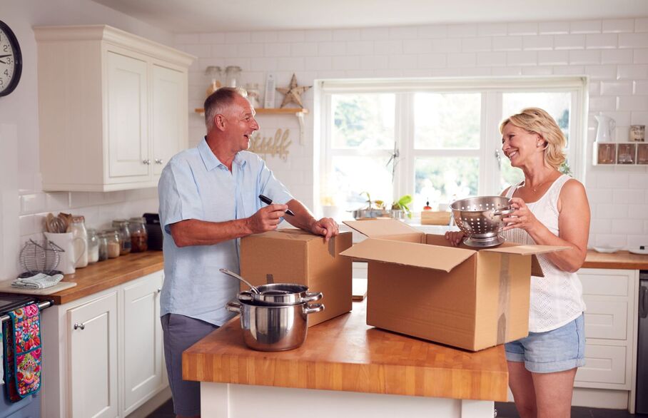 A couple packing up their kitchen