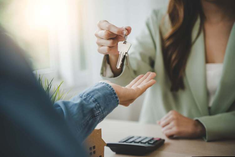 A person handing over a set of house keys