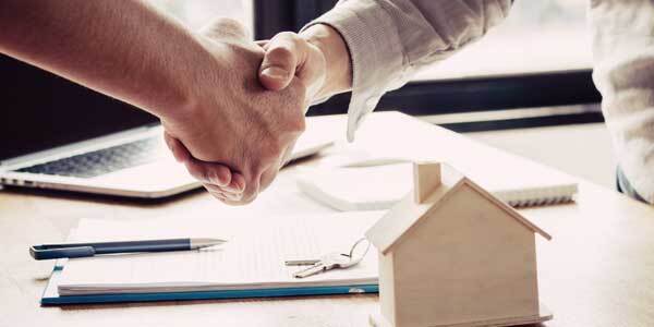 Shaking hands over agreed landlord paperwork 