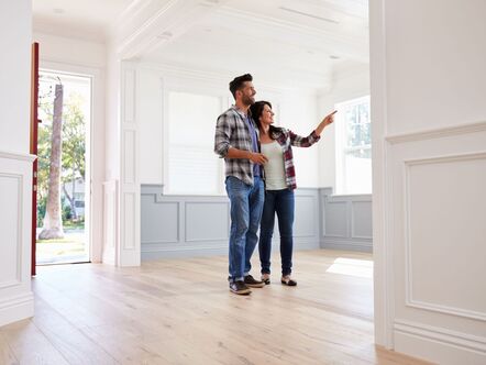 Two people viewing an empty house