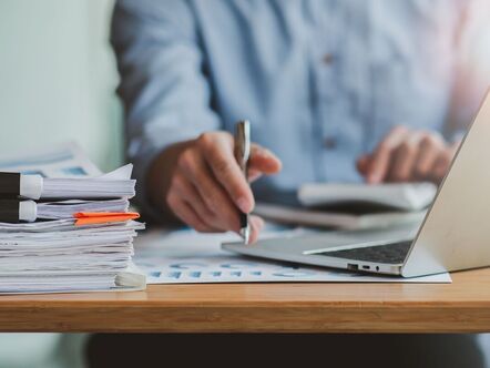 Man at a desk looking at paperwork