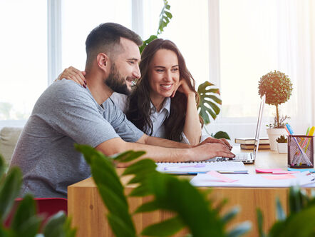 Two people reading a computer screen