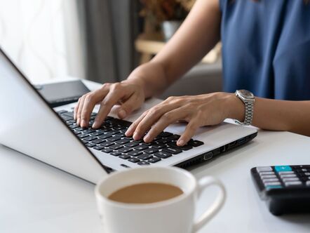 Someone typing on a laptop