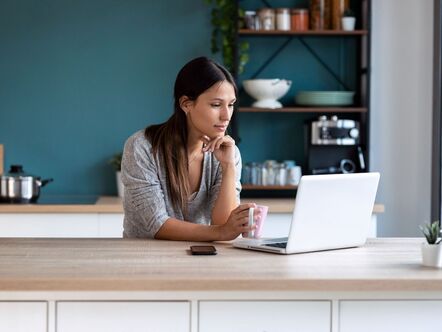 Someone on their laptop in a kitchen